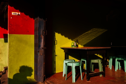 Prints - How can I help you?  -  ManÂ´s shadow in a cafÃ© in Manila. 40x60 cm.  Pigment inkject printed in Luster paper. 2016.