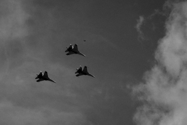 Three air force planes fly over Caracas during a military...