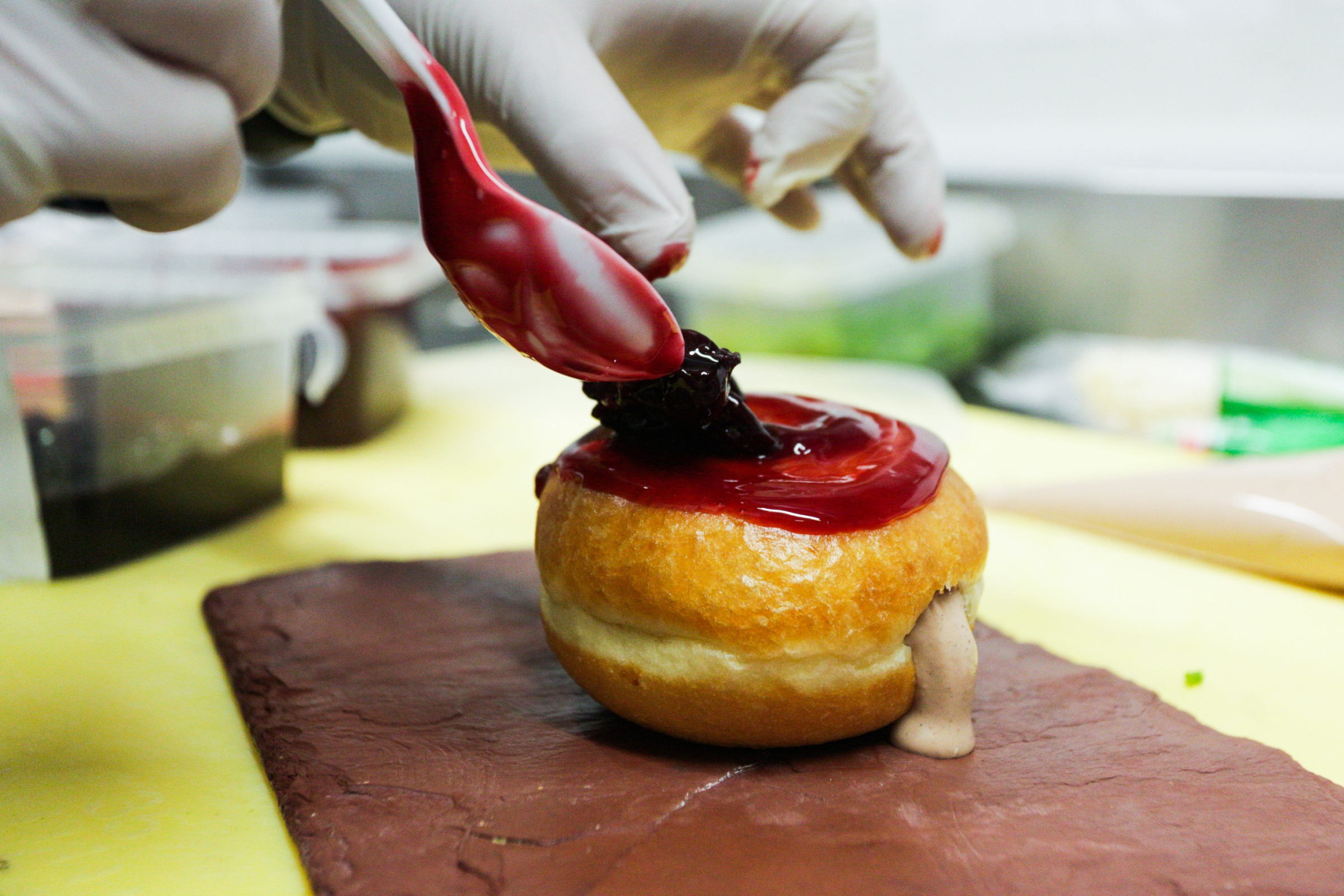 A chicken liver mousse-filled donut is prepared at the...